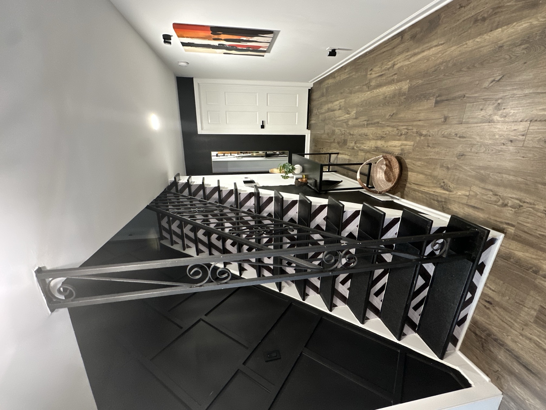 The Foyer — geometric stair tile and wood feature wall